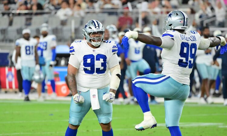 Dallas Cowboys offensive tackle Marcellus Johnson locks up Seattle Seahawks linebacker Aidan Hubbard at the line.