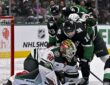 Minnesota Wild goaltender Jesper Wallstedt smothers the puck as Dallas Stars center Sam Steel crashes the net.