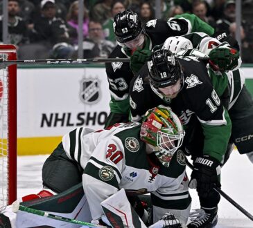 Minnesota Wild goaltender Jesper Wallstedt smothers the puck as Dallas Stars center Sam Steel crashes the net.