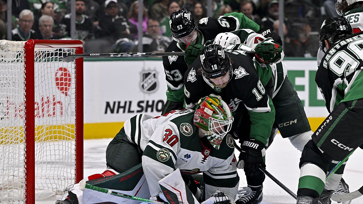 Minnesota Wild goaltender Jesper Wallstedt smothers the puck as Dallas Stars center Sam Steel crashes the net.
