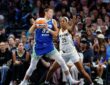 Dallas Wings forward Jessica Shepard secures the ball as Indiana Fever forward Monique Billings defends with both hands up.