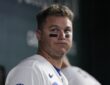 Texas Rangers designated hitter Joc Pederson stands in the dugout in eye black at Globe Life Field.