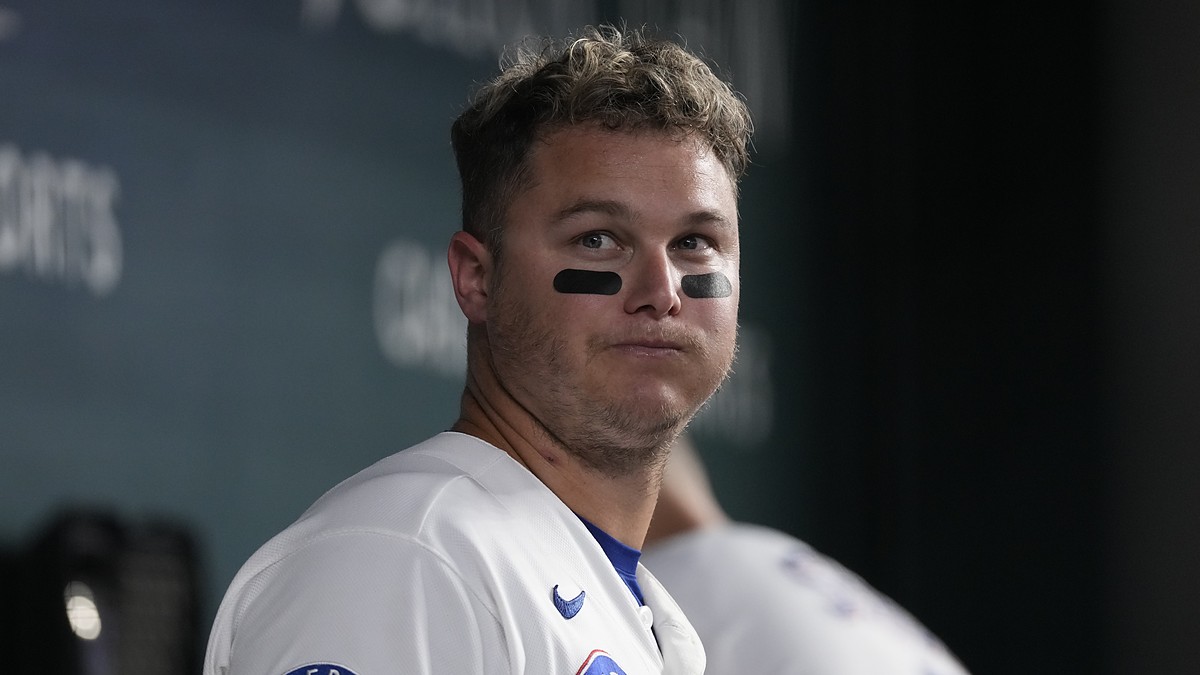 Texas Rangers designated hitter Joc Pederson stands in the dugout in eye black at Globe Life Field.