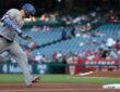 Texas Rangers designated hitter Joc Pederson rounds third base with his head down after hitting a home run.