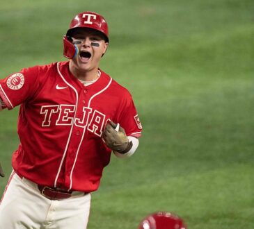 Texas Rangers designated hitter Joc Pederson shouts and flips his bat after connecting on a home run.