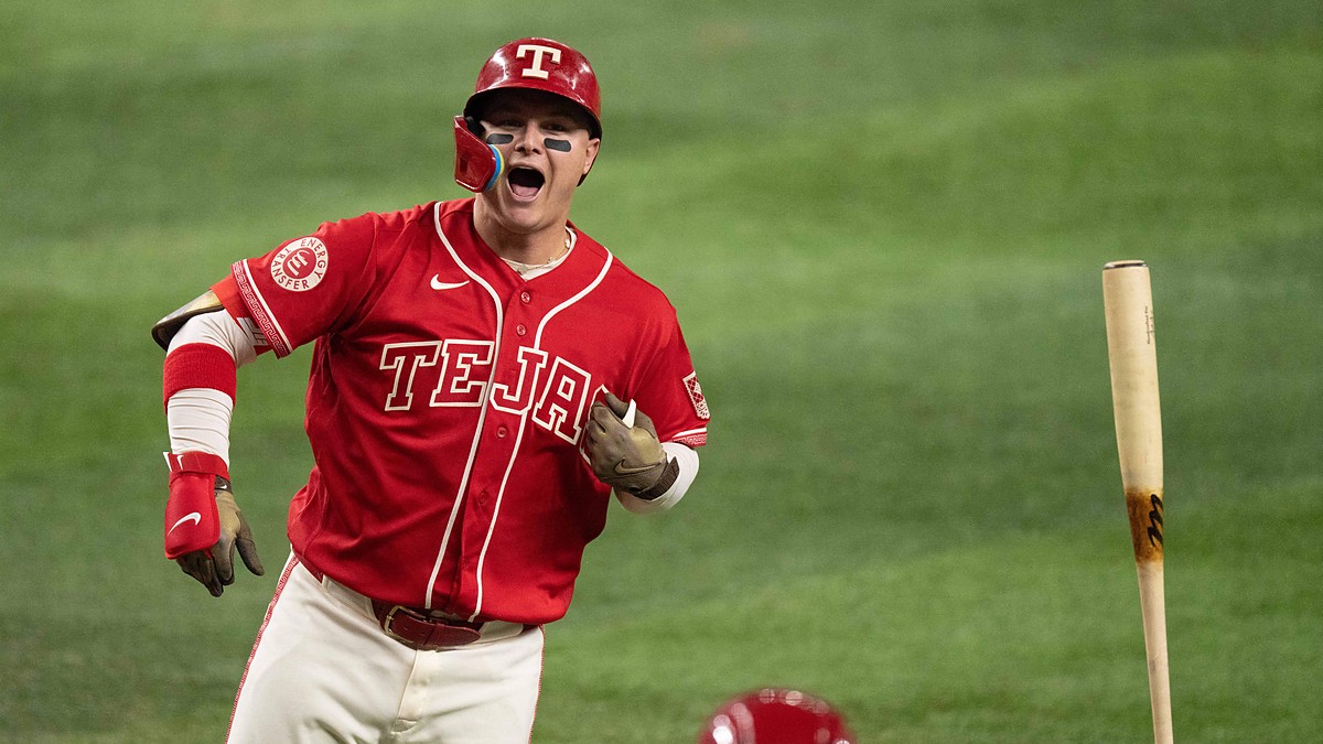 Texas Rangers designated hitter Joc Pederson shouts and flips his bat after connecting on a home run.