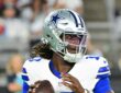 Dallas Cowboys quarterback Joe Milton III drops back to pass in his No. 10 jersey against the Cardinals.