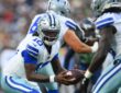 Dallas Cowboys quarterback Joe Milton III extends the ball on a handoff to a teammate in the backfield.
