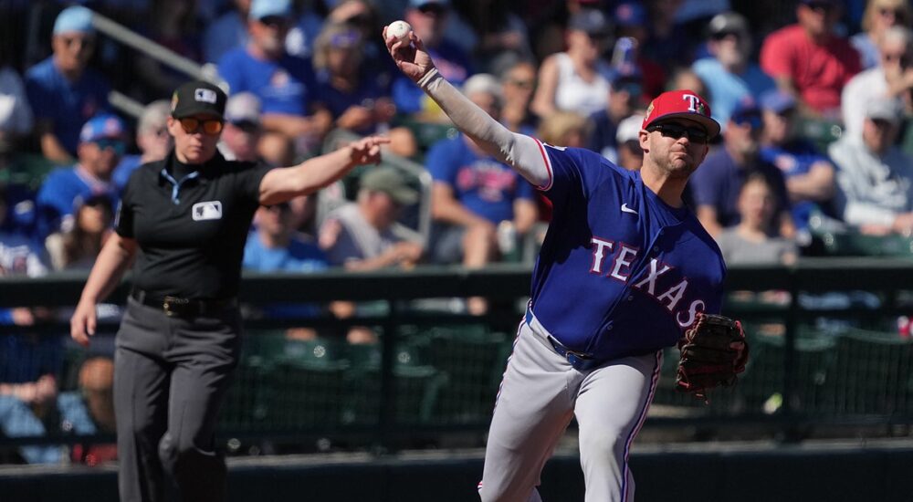 Rangers infielder Jonah Bride throws across the diamond as an umpire signals in the background
