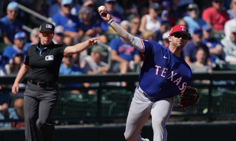 Rangers infielder Jonah Bride throws across the diamond as an umpire signals in the background