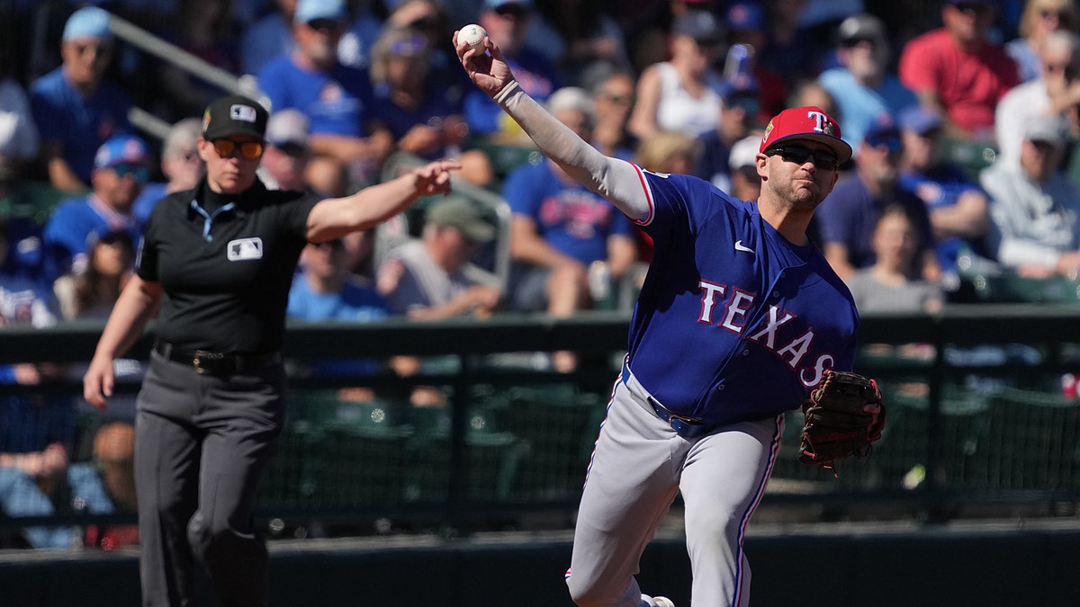 Rangers infielder Jonah Bride throws across the diamond as an umpire signals in the background