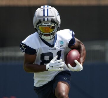 Dallas Cowboys wide receiver Jonathan Mingo celebrates with the ball after a first-down catch at AT&T Stadium.