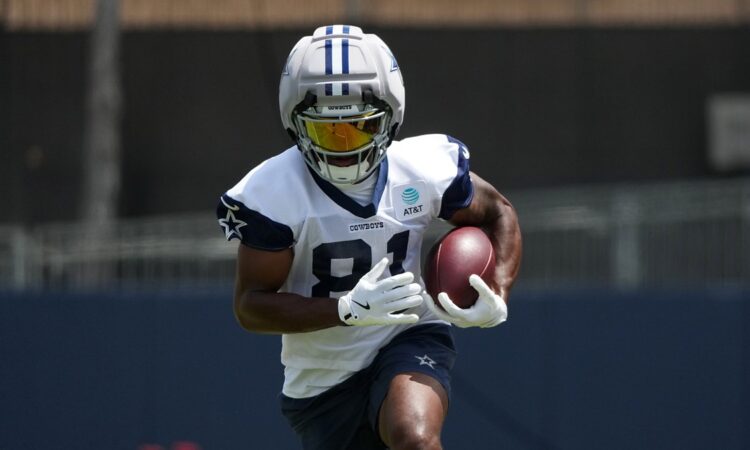 Dallas Cowboys wide receiver Jonathan Mingo celebrates with the ball after a first-down catch at AT&T Stadium.