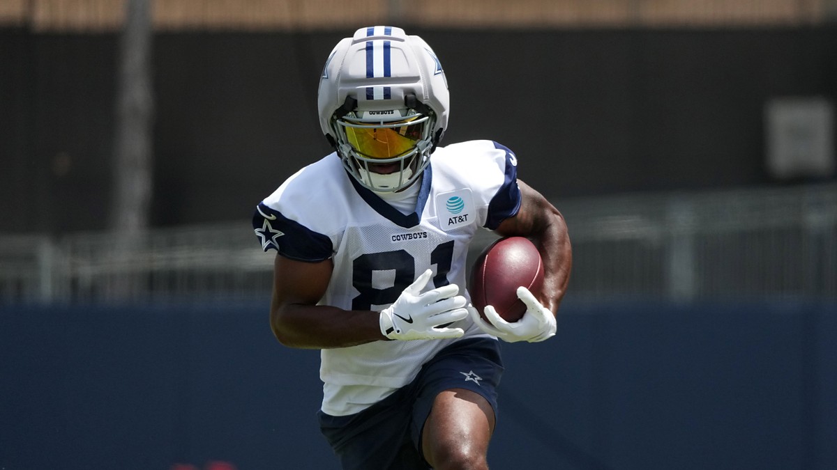 Dallas Cowboys wide receiver Jonathan Mingo celebrates with the ball after a first-down catch at AT&T Stadium.