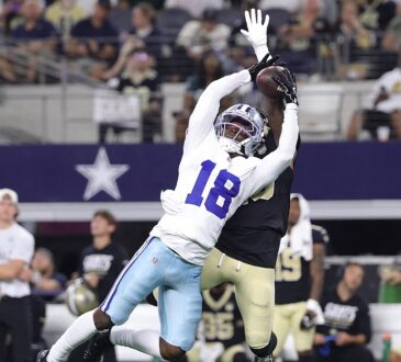 Dallas Cowboys wide receiver Jordan Hudson stretches to make a catch over a New Orleans Saints defender.