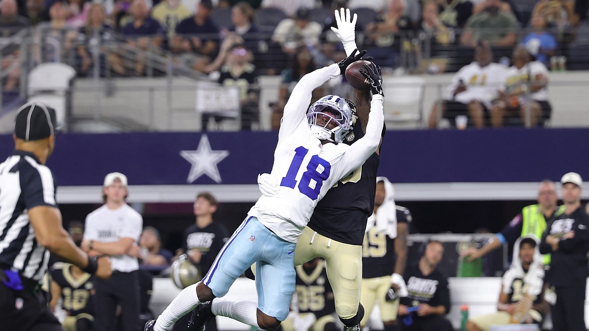 Dallas Cowboys wide receiver Jordan Hudson stretches to make a catch over a New Orleans Saints defender.
