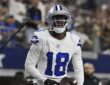 Dallas Cowboys wide receiver Jordan Hudson grins while holding the ball after scoring a touchdown.