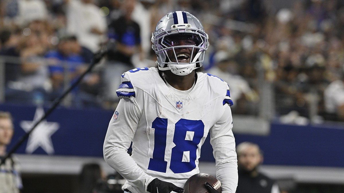 Dallas Cowboys wide receiver Jordan Hudson grins while holding the ball after scoring a touchdown.