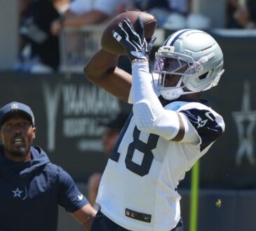 Dallas Cowboys wide receiver Jordan Hudson reaches up to catch a pass during a training camp practice.