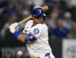 Texas Rangers third baseman Josh Jung turns away and winces as a pitch strikes him at the plate.