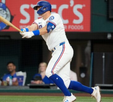 Texas Rangers third baseman Josh Jung follows through on a single against the Chicago White Sox at Globe Life Field.