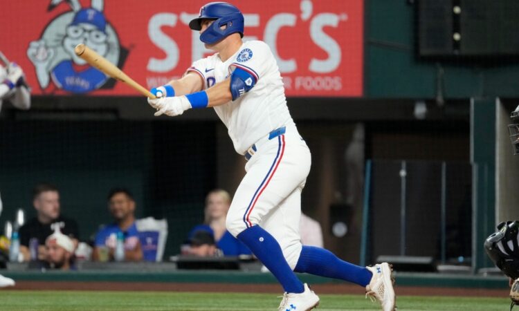 Texas Rangers third baseman Josh Jung follows through on a single against the Chicago White Sox at Globe Life Field.