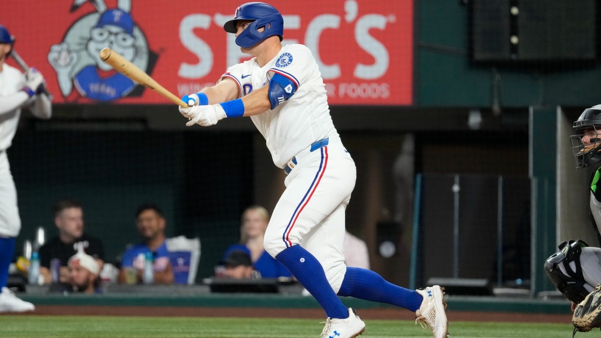 Texas Rangers third baseman Josh Jung follows through on a single against the Chicago White Sox at Globe Life Field.