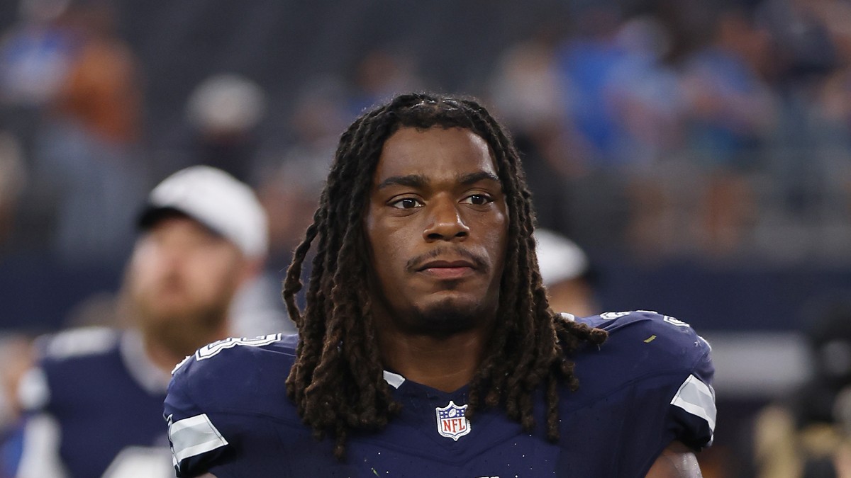 Dallas Cowboys safety Julius Wood walks off the field carrying his helmet after a game.