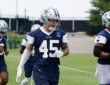 Dallas Cowboys linebacker Justin Barron jogs through a drill in a practice jersey during minicamp.