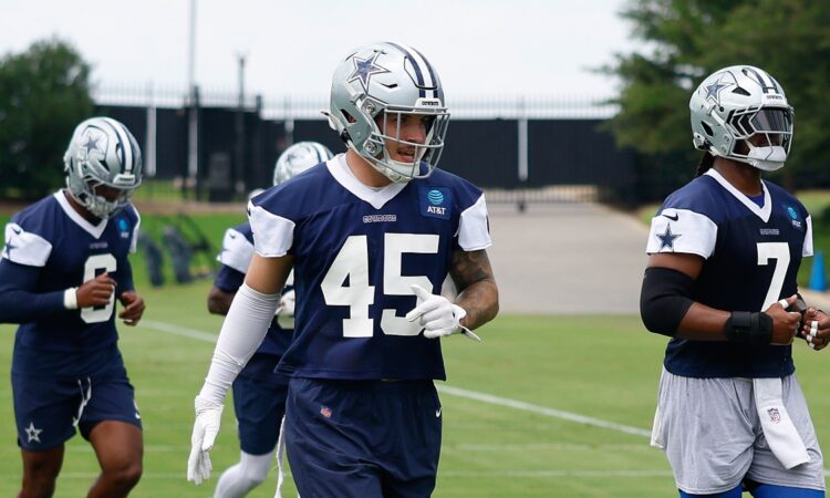 Dallas Cowboys linebacker Justin Barron jogs through a drill in a practice jersey during minicamp.