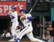 Texas Rangers designated hitter Justin Foscue watches his solo home run after finishing his swing.