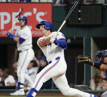 Texas Rangers designated hitter Justin Foscue watches his solo home run after finishing his swing.