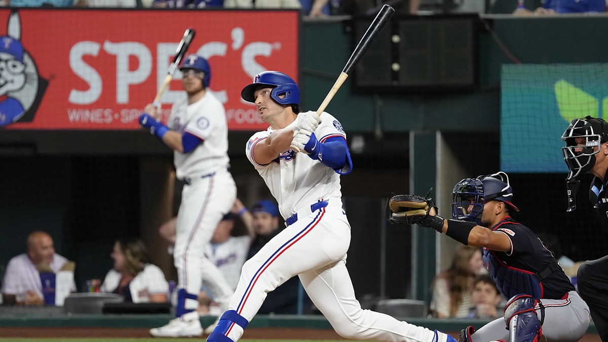 Texas Rangers designated hitter Justin Foscue watches his solo home run after finishing his swing.