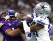 Minnesota Vikings wide receiver Justin Jefferson and Dallas Cowboys cornerback Caelen Carson grapple after a play.