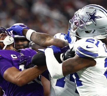 Minnesota Vikings wide receiver Justin Jefferson and Dallas Cowboys cornerback Caelen Carson grapple after a play.