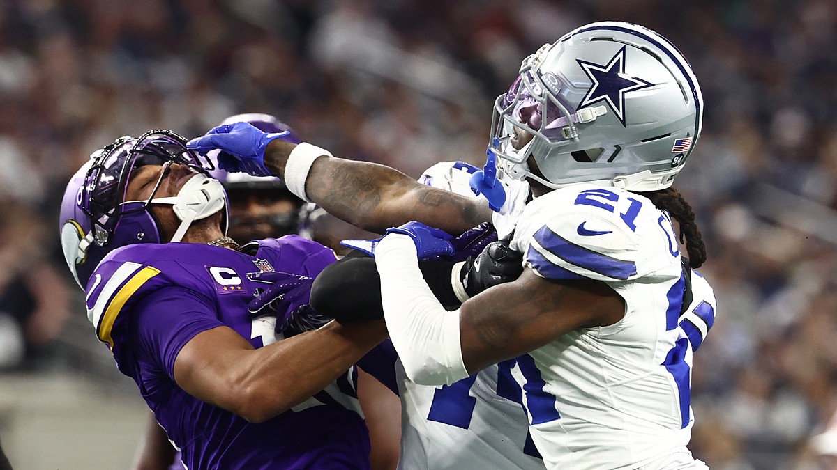 Minnesota Vikings wide receiver Justin Jefferson and Dallas Cowboys cornerback Caelen Carson grapple after a play.