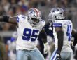 Cowboys defensive tackle Kenny Clark celebrates a sack alongside defensive end Donovan Ezeiruaku at midfield