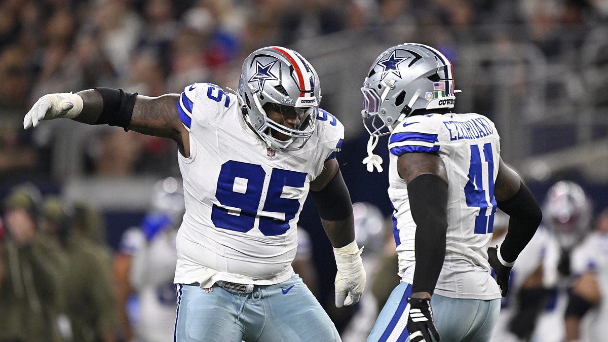 Cowboys defensive tackle Kenny Clark celebrates a sack alongside defensive end Donovan Ezeiruaku at midfield