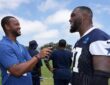 Cowboys defensive tackle Kenny Clark laughs during a sideline interview at training camp in his practice jersey