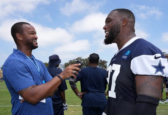 Cowboys defensive tackle Kenny Clark laughs during a sideline interview at training camp in his practice jersey