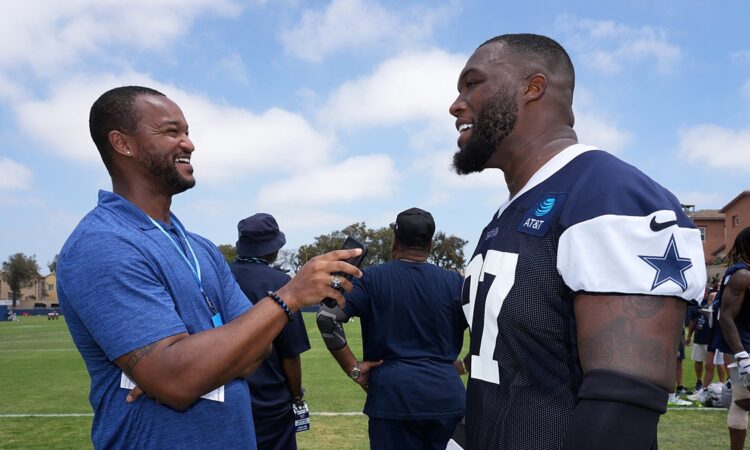 Cowboys defensive tackle Kenny Clark laughs during a sideline interview at training camp in his practice jersey
