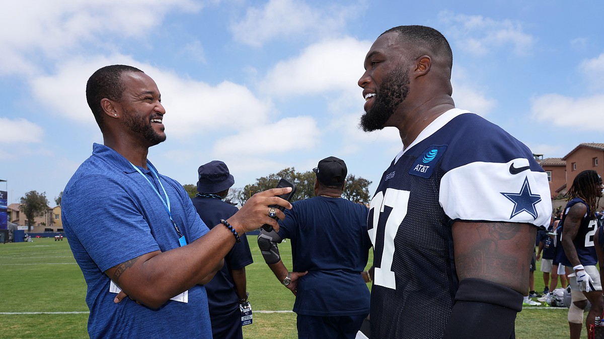 Cowboys defensive tackle Kenny Clark laughs during a sideline interview at training camp in his practice jersey