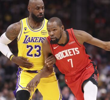 Houston Rockets forward Kevin Durant #7 dribbles the ball against defense from Los Angeles Lakers forward LeBron James #23 at Toyota Center.