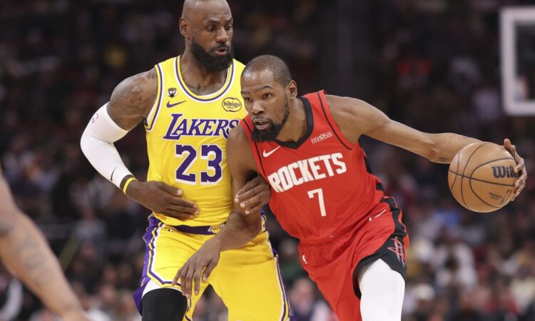 Houston Rockets forward Kevin Durant #7 dribbles the ball against defense from Los Angeles Lakers forward LeBron James #23 at Toyota Center.