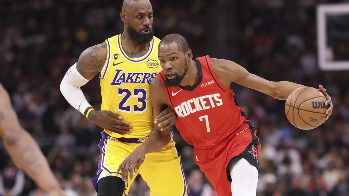 Houston Rockets forward Kevin Durant #7 dribbles the ball against defense from Los Angeles Lakers forward LeBron James #23 at Toyota Center.