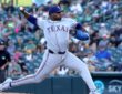 Texas Rangers starting pitcher Kumar Rocker strides toward the plate with the ball cocked behind him.