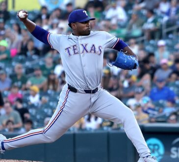 Texas Rangers starting pitcher Kumar Rocker strides toward the plate with the ball cocked behind him.