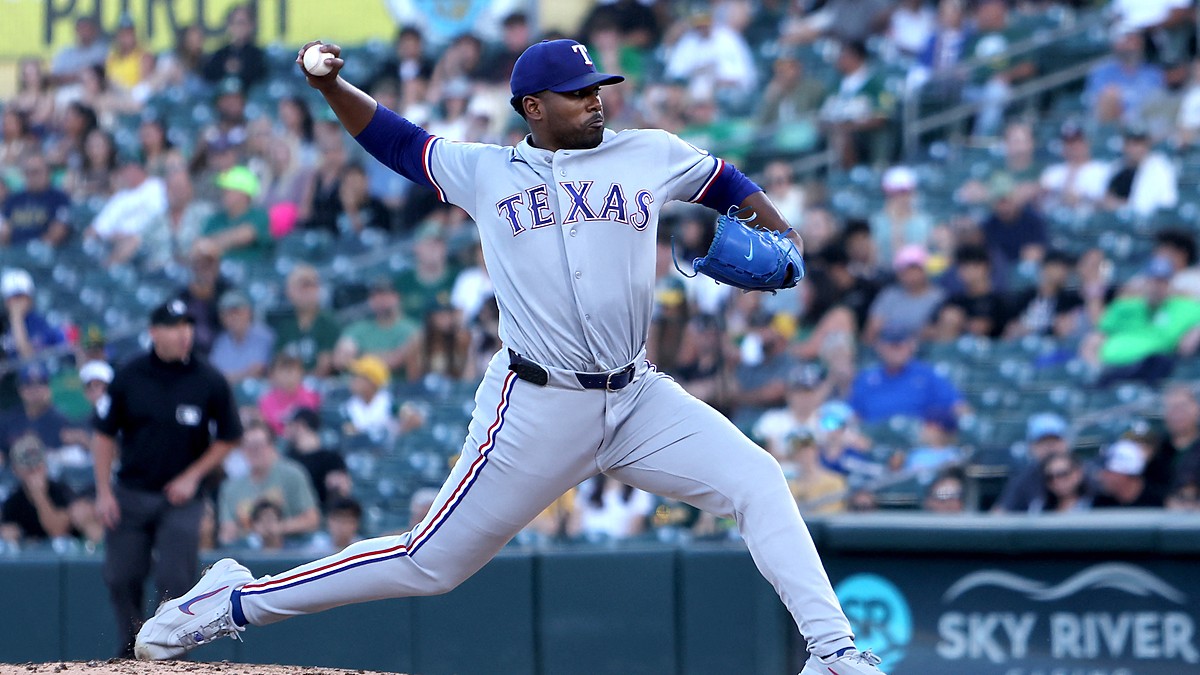 Texas Rangers starting pitcher Kumar Rocker strides toward the plate with the ball cocked behind him.