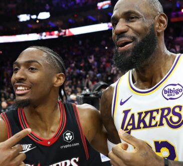Los Angeles Lakers forward LeBron James #23 meets with Philadelphia 76ers guard Tyrese Maxey after the game at Xfinity Mobile Arena.