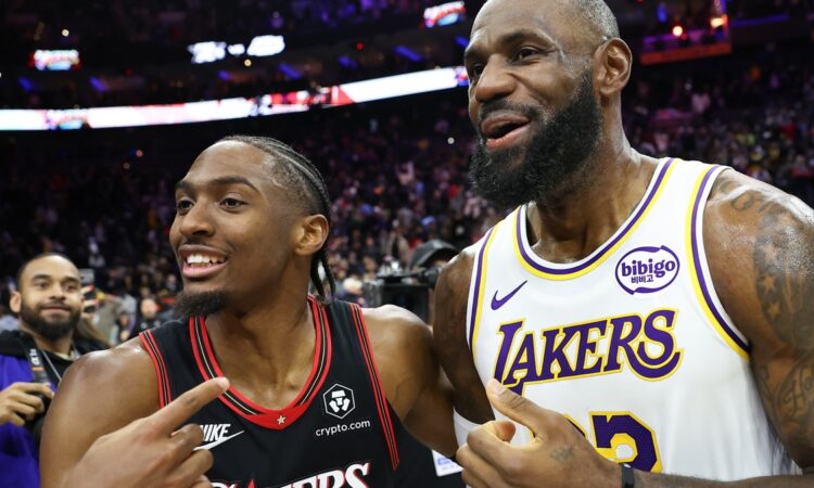 Los Angeles Lakers forward LeBron James #23 meets with Philadelphia 76ers guard Tyrese Maxey after the game at Xfinity Mobile Arena.